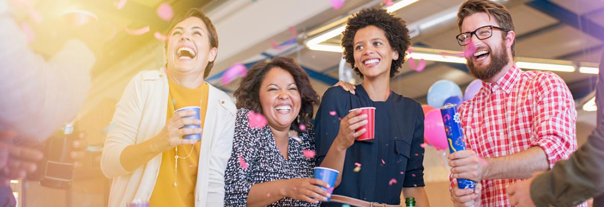 Group of coworkers laughing and enjoying a party
