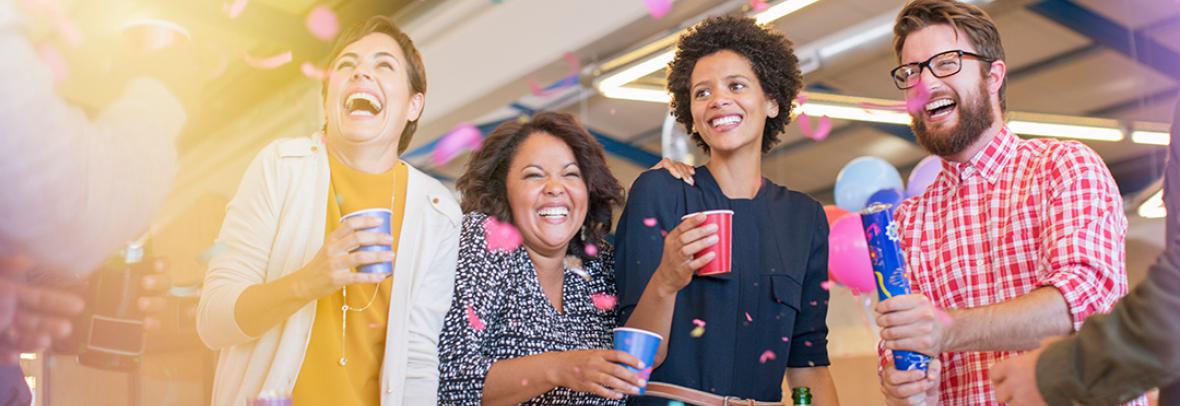 Group of coworkers laughing and enjoying a party