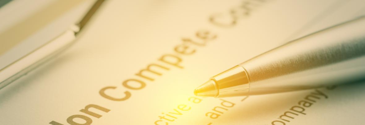 Blue pen and a non compete contract on a clipboard. Noncompete contract is an agreement between employee and employer, not to enter into competition in subsequence business effort