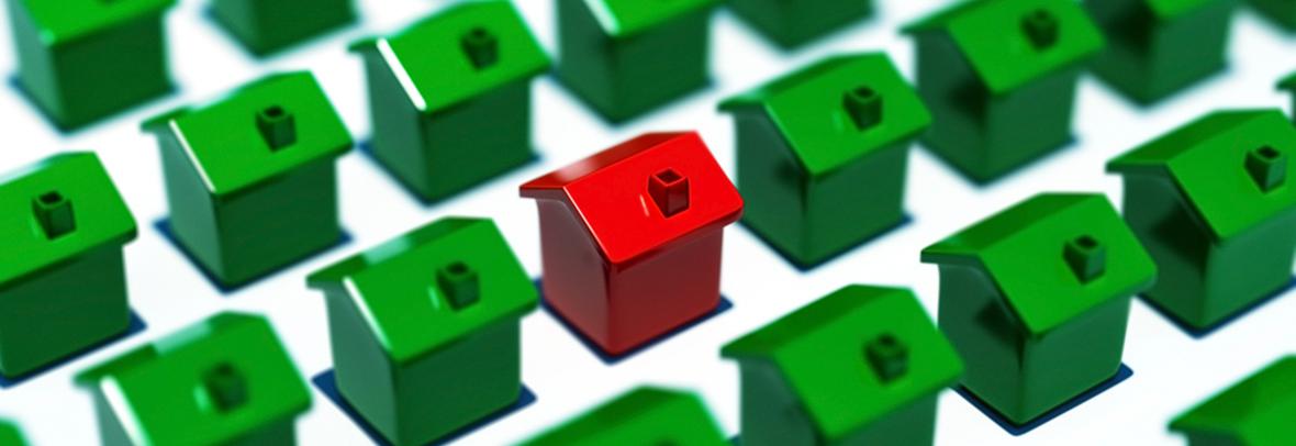 photo of many green toy houses with one highlighted in red