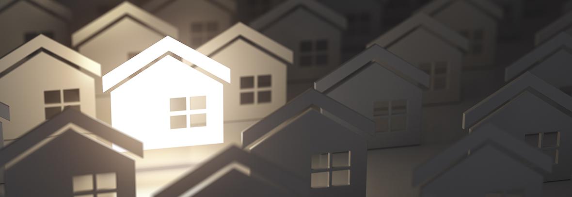 illustration of many house cutouts with one illuminated in white