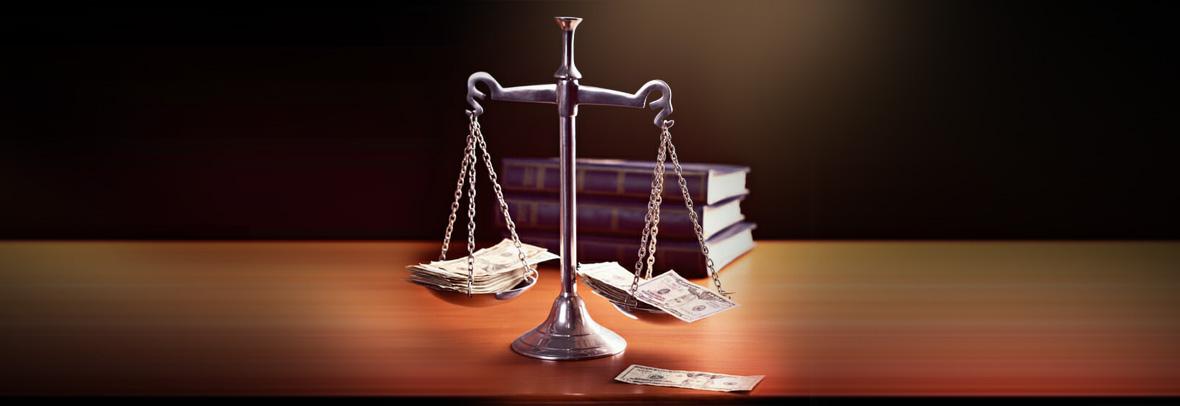 Model scales of justice are weighted with banknotes. The scale are weighed down with banknotes.