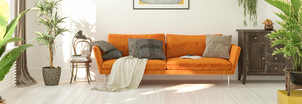 Photo of a living room with a modern orange couch and other modern decor