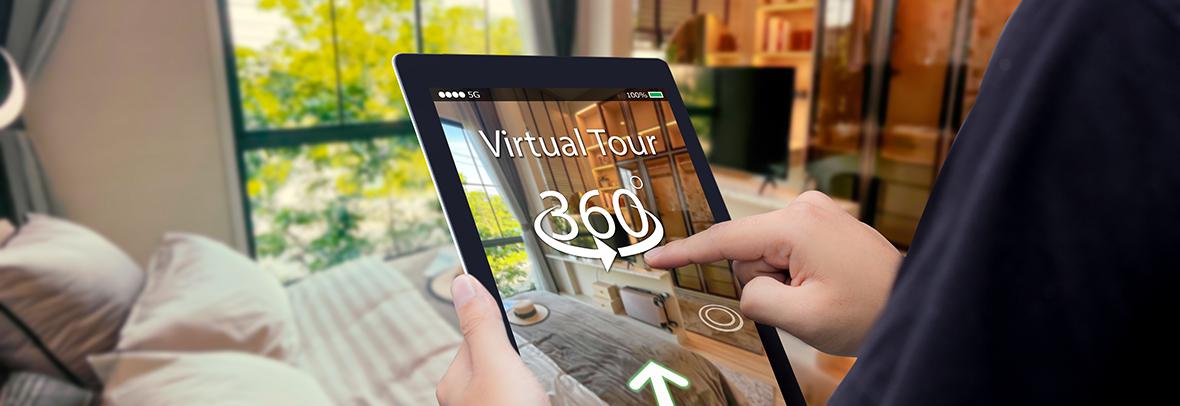Photo of a person holding a tablet with a virtual tour of a home on the tablet