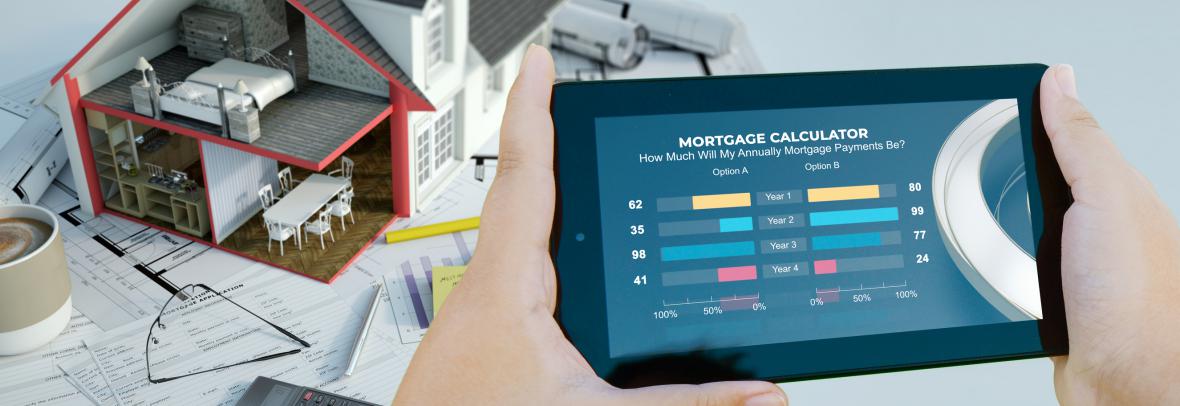 hands holding a phone displaying mortgage calculator with small model home over papers in background