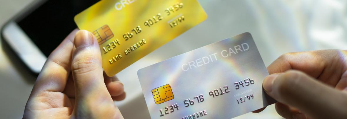 Close up Hand holding Blank credit card black,gold,platinum color with spectrum light and shadow background