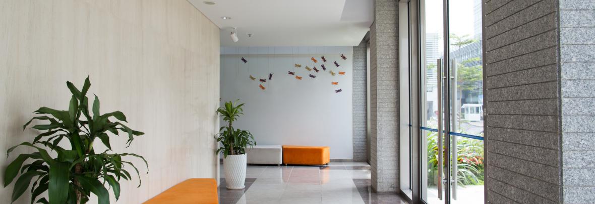 Empty entrance of condominium building. Glass doors and hall of hotel building. Living space concept