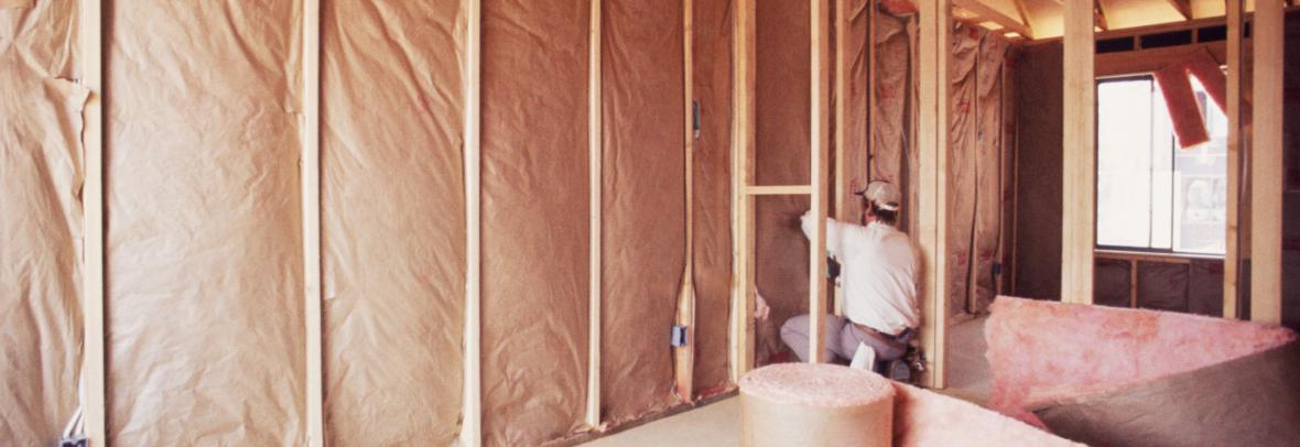 Installing insulation into wall of new home
