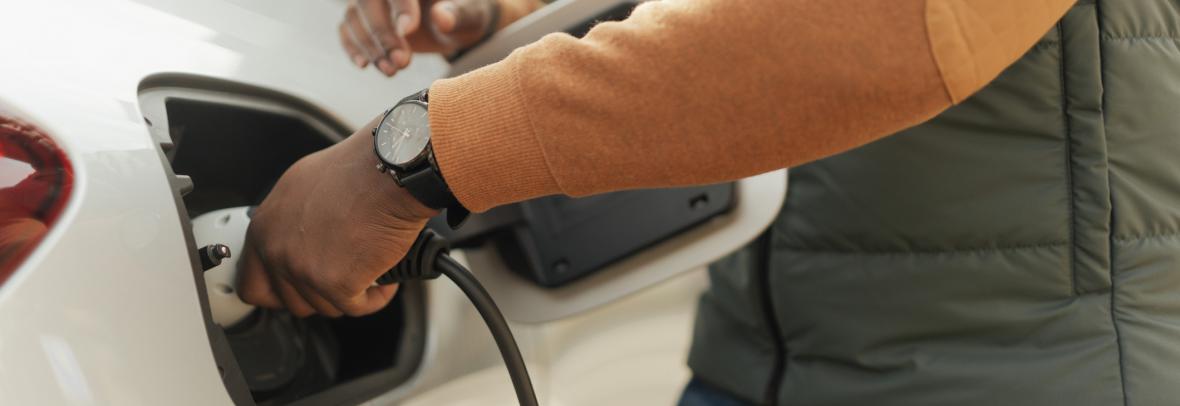 Close-up of man charging electric car
