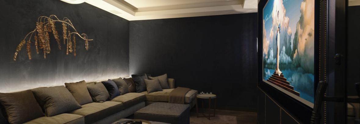 Chic home theater in dark tones and extended sofa seating