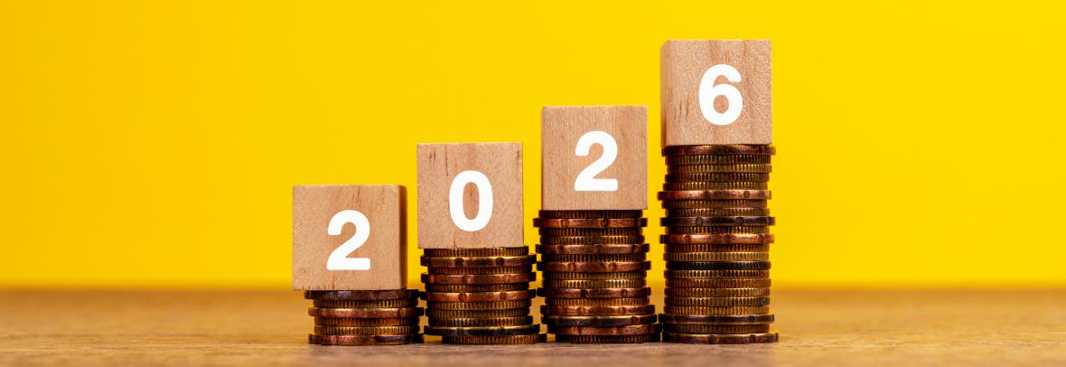2026 on Wood Block on Top of Stack of Coins