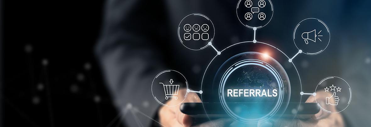 photo illustration of a person holding a table with the word Referrals on top and icons of multiple people connecting