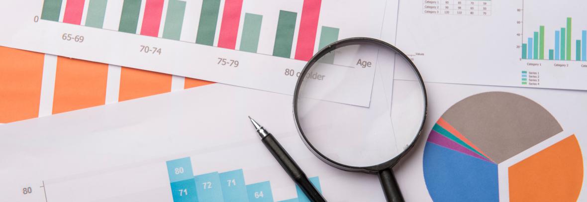 graphs and data with magnifying glass