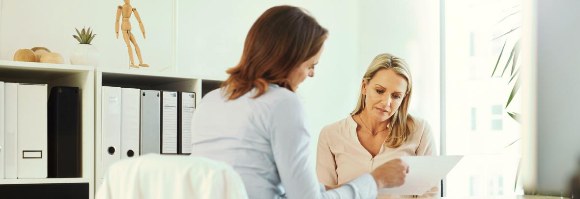 women looking at paperwork filling out forms