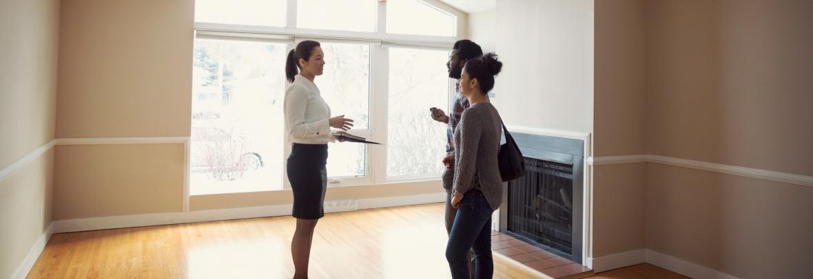 woman showing buyers a house