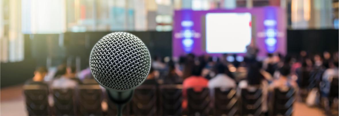 microphone in front of people gathered for a speech