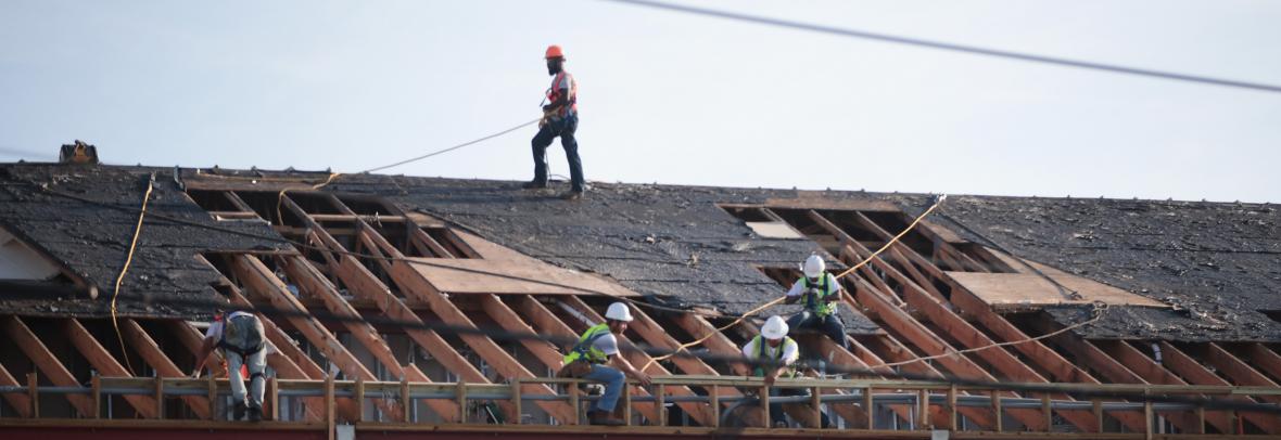 Workers fixing a roof