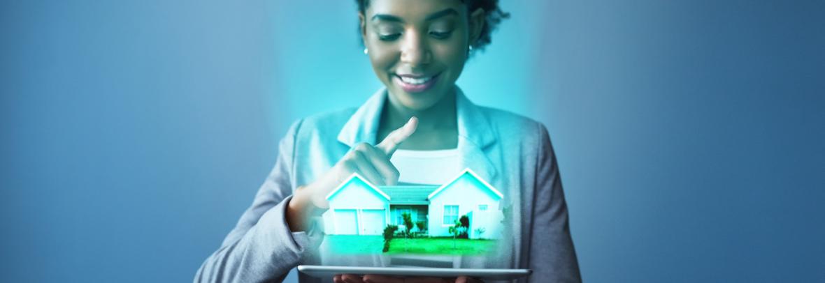 woman holding model of a house