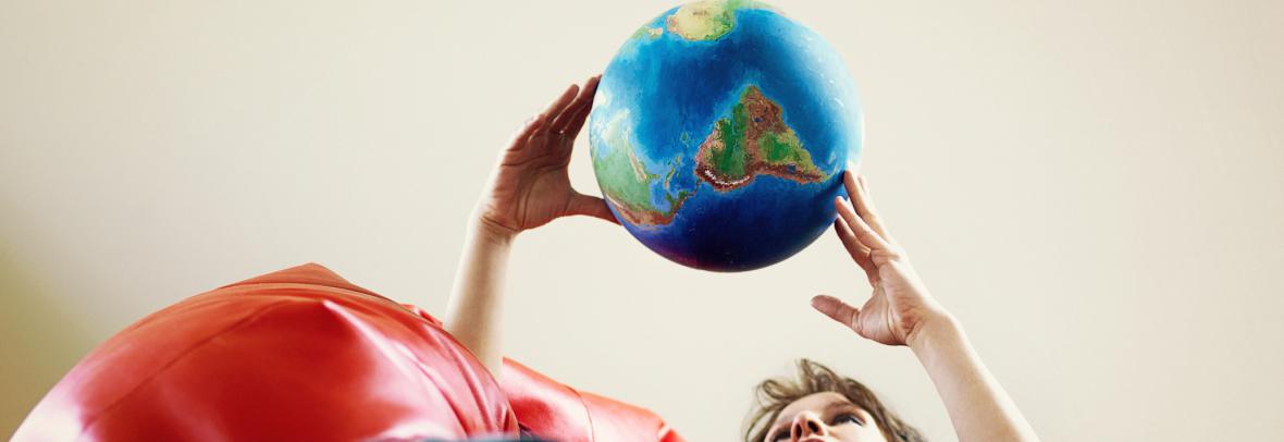 woman holding a globe