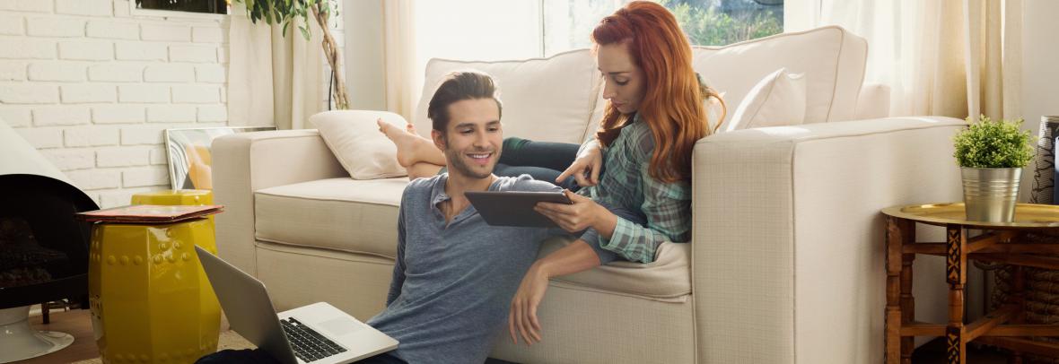 couple in living room looking at computer