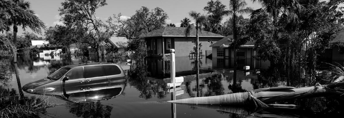 minivan submerged in floodwaters in neighborhood