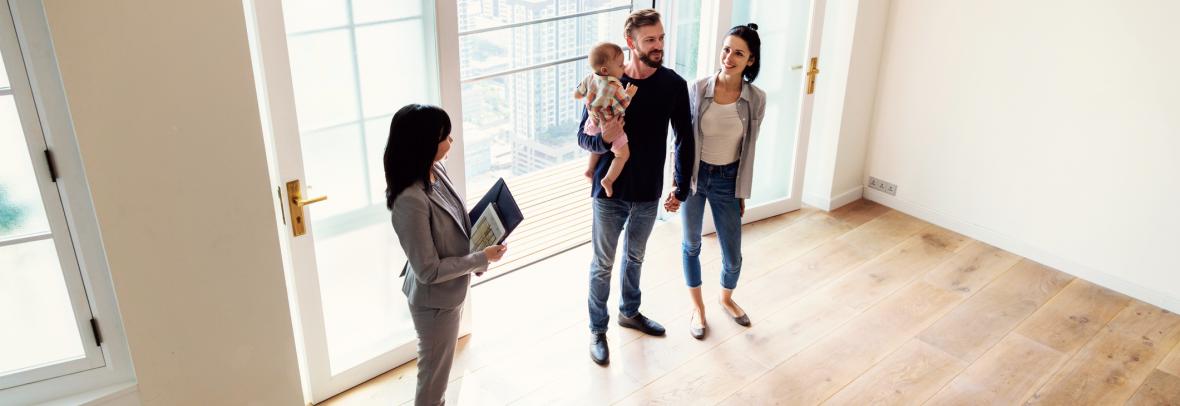 realtor shows a family a house