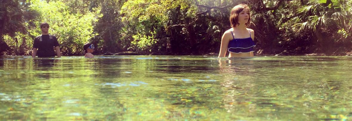 Girl wades in a Florida spring