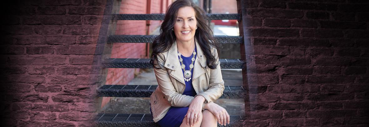 Linda Yates sitting on staircase outdoors