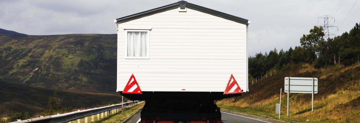 house being moved on a road via truck