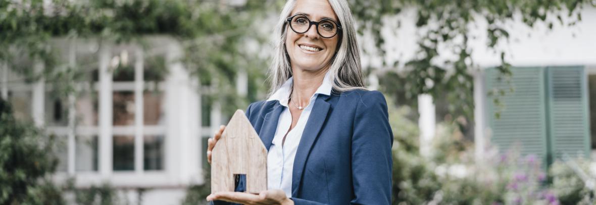 Realtor holding a model home