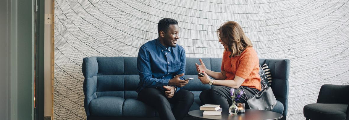 Man and woman on couch talking