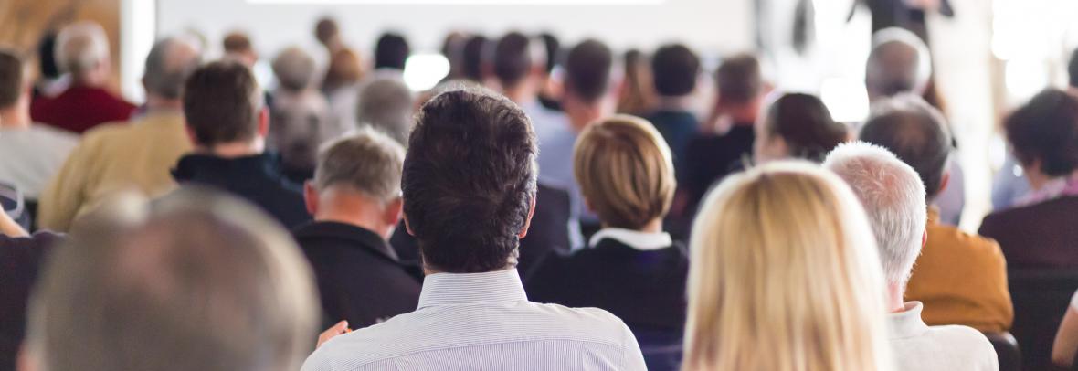 People at a conference looking at a screen