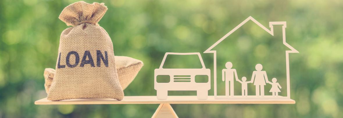 House car and loan money on a balance scale