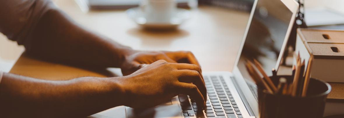 man typing on a computer