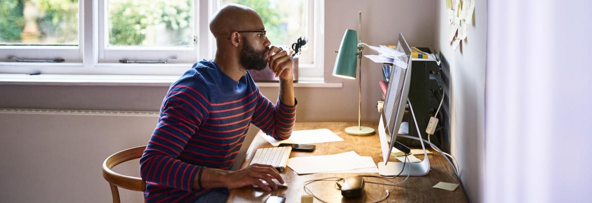 Man at desk looking at computer