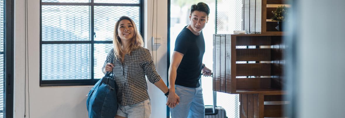 Young couple entering house