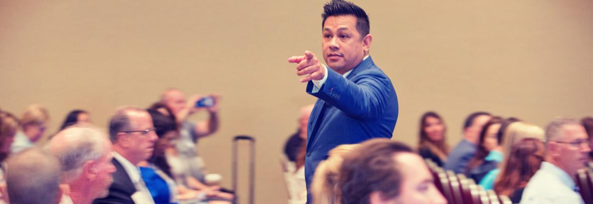 man speaking to convention-goers