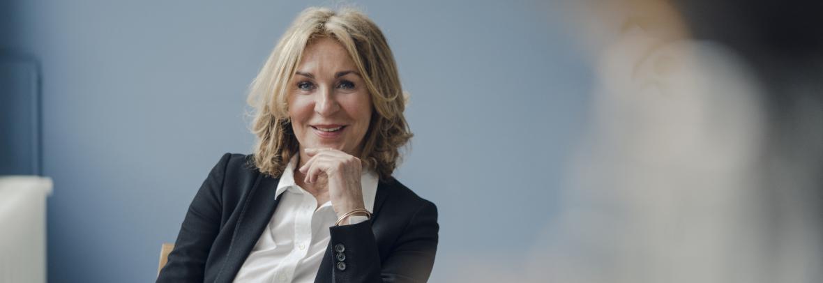 Businesswoman sitting in chair and smiling