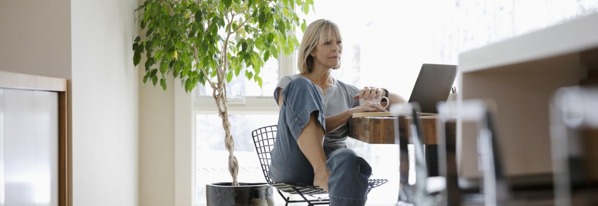 woman in kitchen using laptop