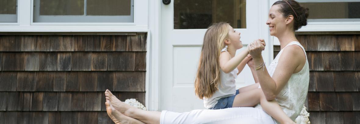 mother and young daughter on porch steps