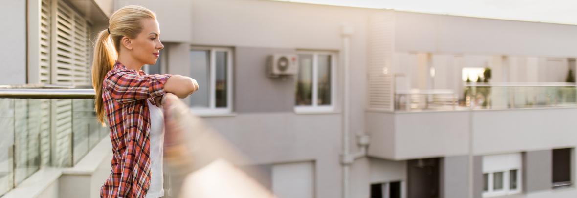 woman on apartment building balcony