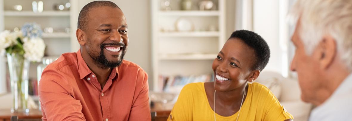 Mature black husband shaking hands with senior agent on taking loan.