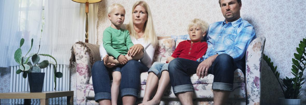 family in sofa in flooded room