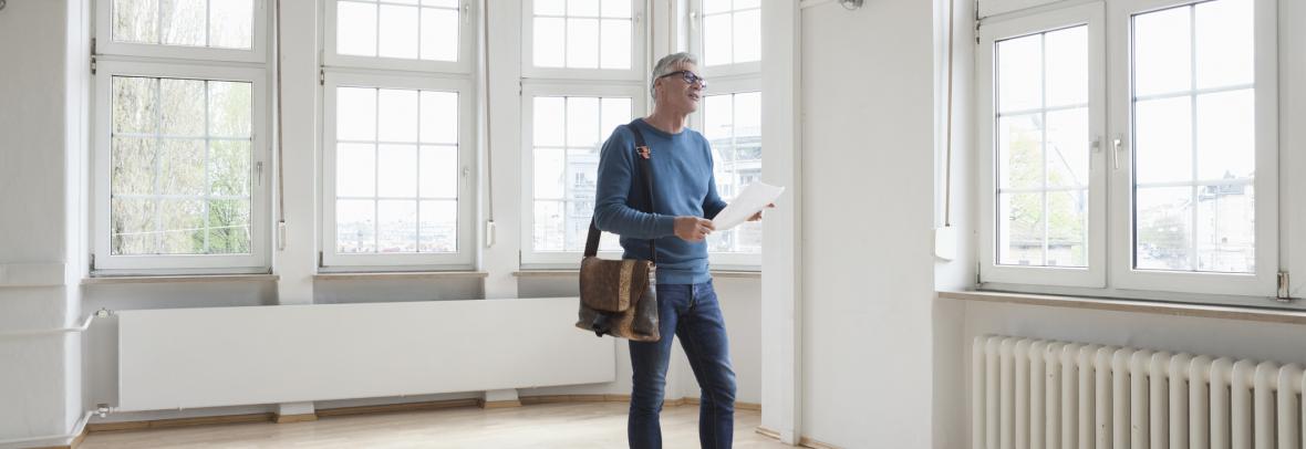 Man looking around in empty apartment