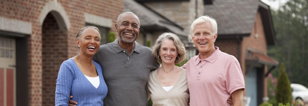 A black and white couple smile for a group photo