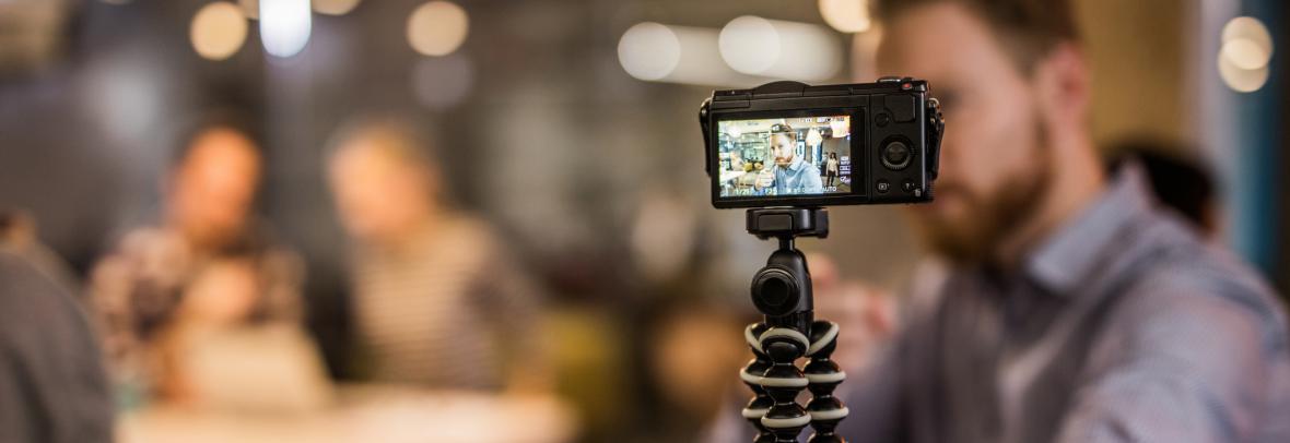 Close up of redhead man making reportage by vlogging.