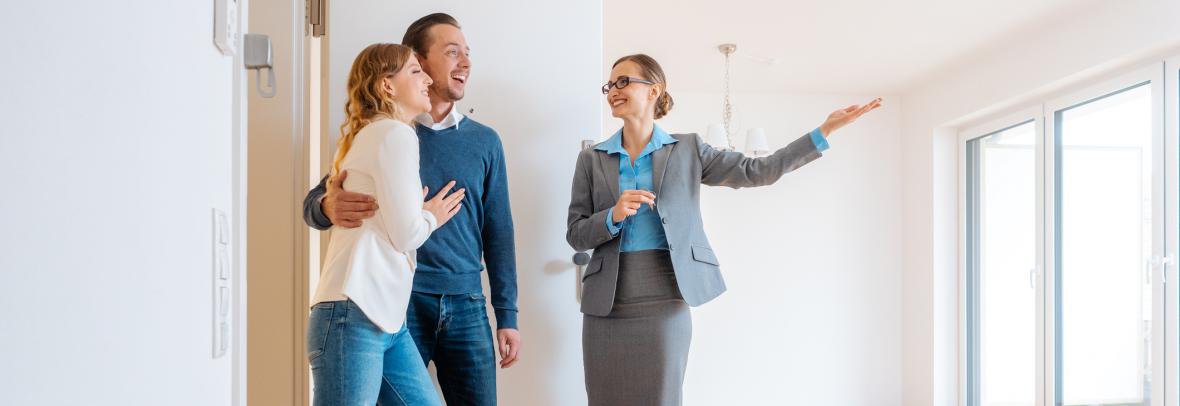 realtor showing a home to a couple