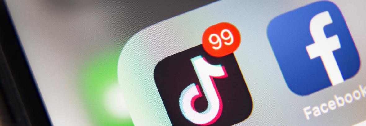 Smart phone screen with icons for TikTok, Facebook and Twitter