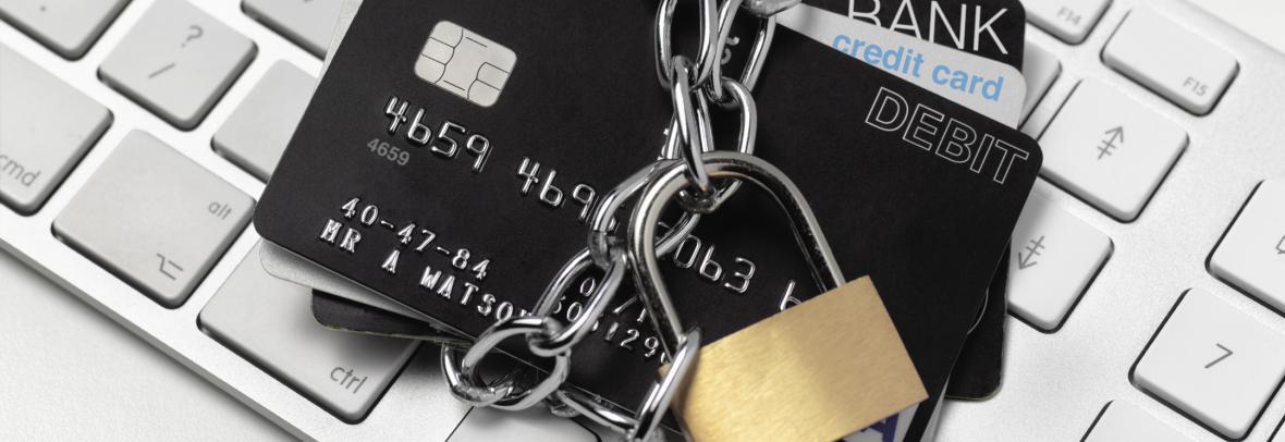 Credit cords with a padlock on top of a keyboard