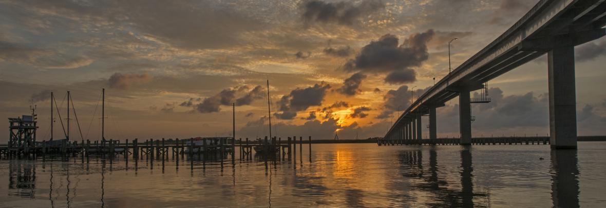 Apalachicola Bay sunset with pilings on the left and bridge on the right